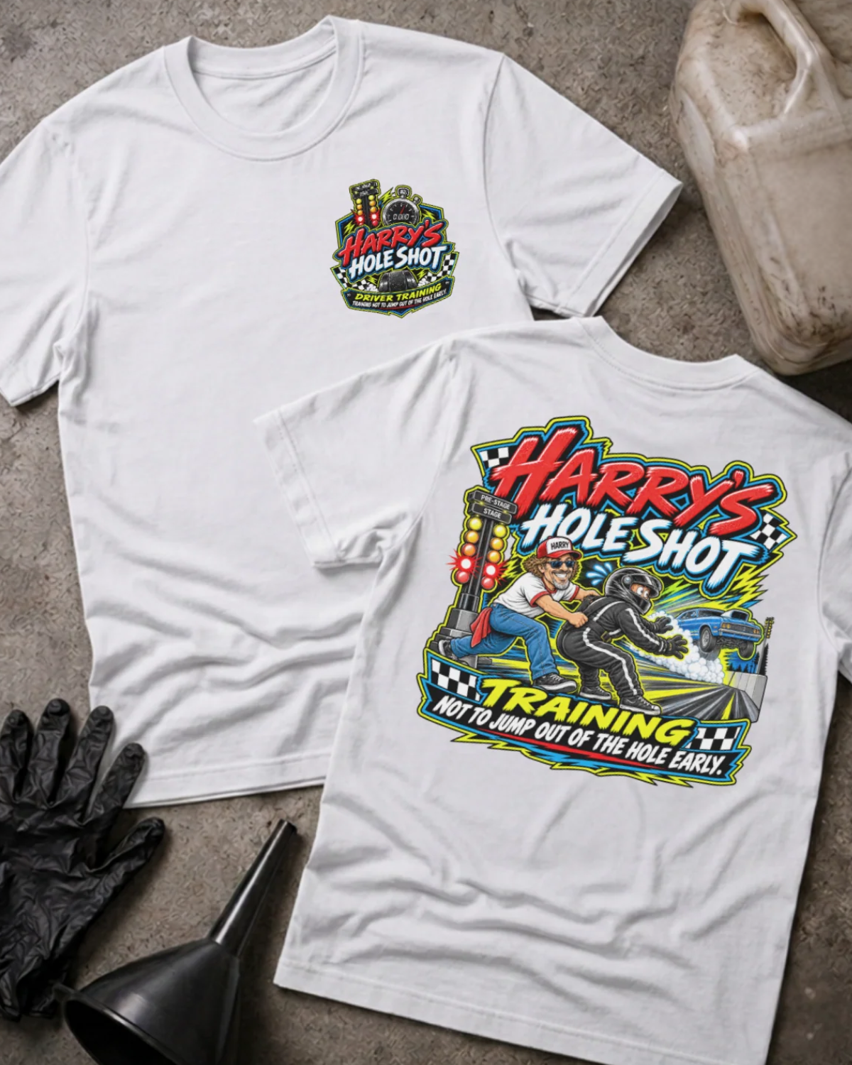 Front and back of Harry’s Hole Shot Training white T-shirt with chest logo, instructor holding back a helmeted racer beside staging lights, and “Not to jump out of the hole early” slogan.