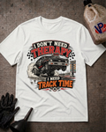 A white graphic t-shirt laid flat on a textured gray surface, featuring a vintage-style racing car illustration and the text 'I DON'T NEED THERAPY I NEED TRACK TIME.' Decorative props including a black glove, funnel, and a plastic jug are placed around the shirt.