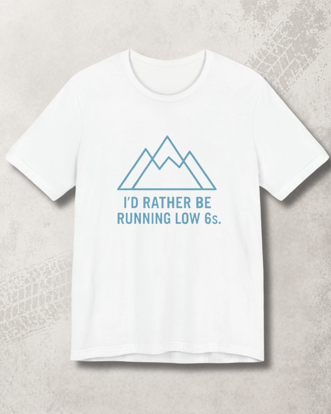 White t-shirt with blue graphic and text on a light gray background