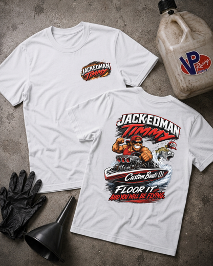 Two white graphic T-shirts laid flat on a gray concrete surface, with a black funnel, black gloves, and a VP Racing fuel jug nearby. The front shirt shows a small chest logo reading 'JACKEDMAN TIMMY,' and the back shirt shows a large racing-style graphic with the same text and a cartoon character.