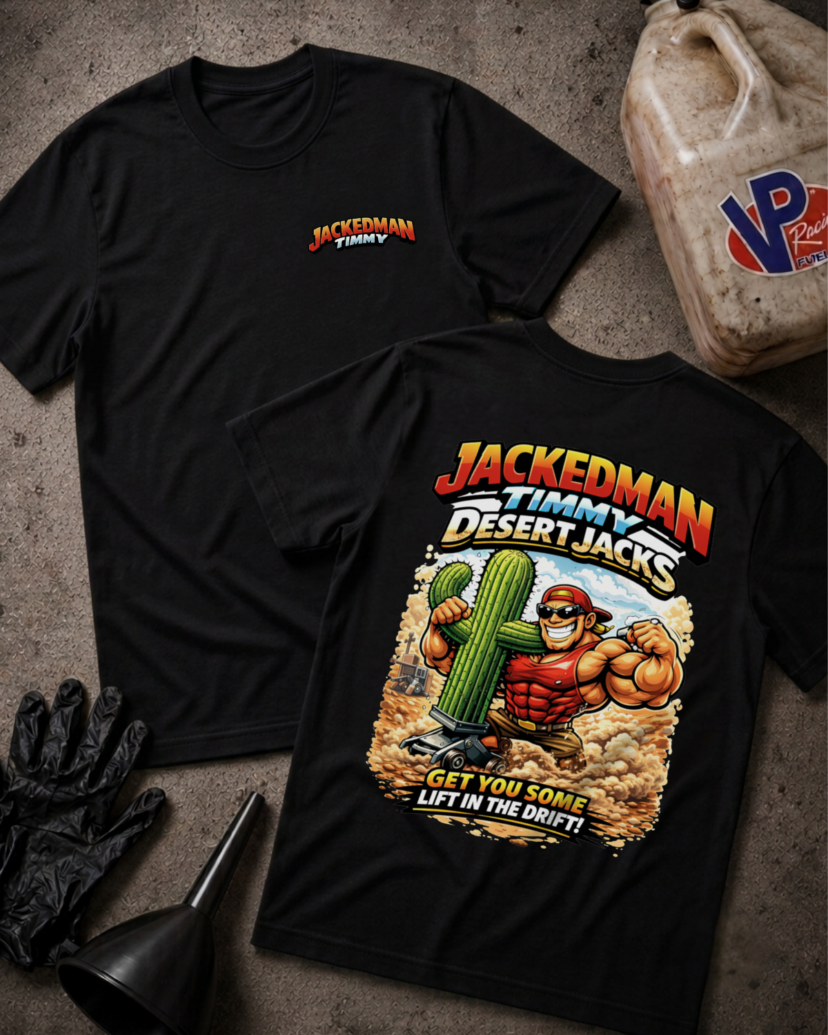 Two black graphic t-shirts laid flat on a textured gray surface, with a black funnel, black gloves, and a plastic gas can nearby. The front shirt shows a small red and yellow 'JACKEDMAN TIMMY' logo on the left chest, and the back shirt features a large colorful graphic of Jackedman lifting a cactus with the text 'JACKEDMAN TIMMY DESERT JACKS' and 'GET YOU SOME LIFT IN THE DRIFT!'.