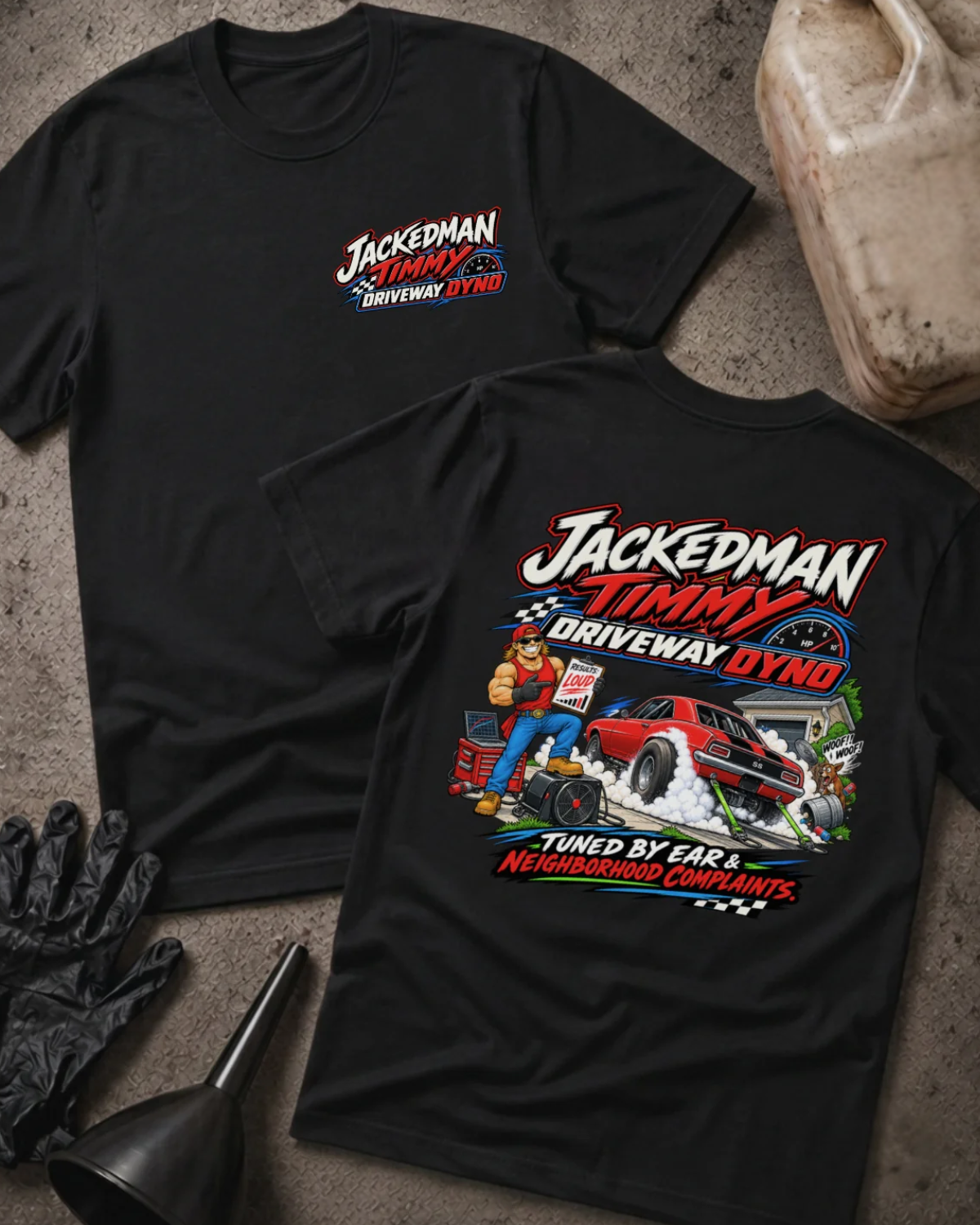 Front and back of Jackedman Timmy Driveway Dyno black T-shirt with chest logo, muscular man beside a red muscle car amid tire smoke, and “Tuned by ear & neighborhood complaints” slogan.