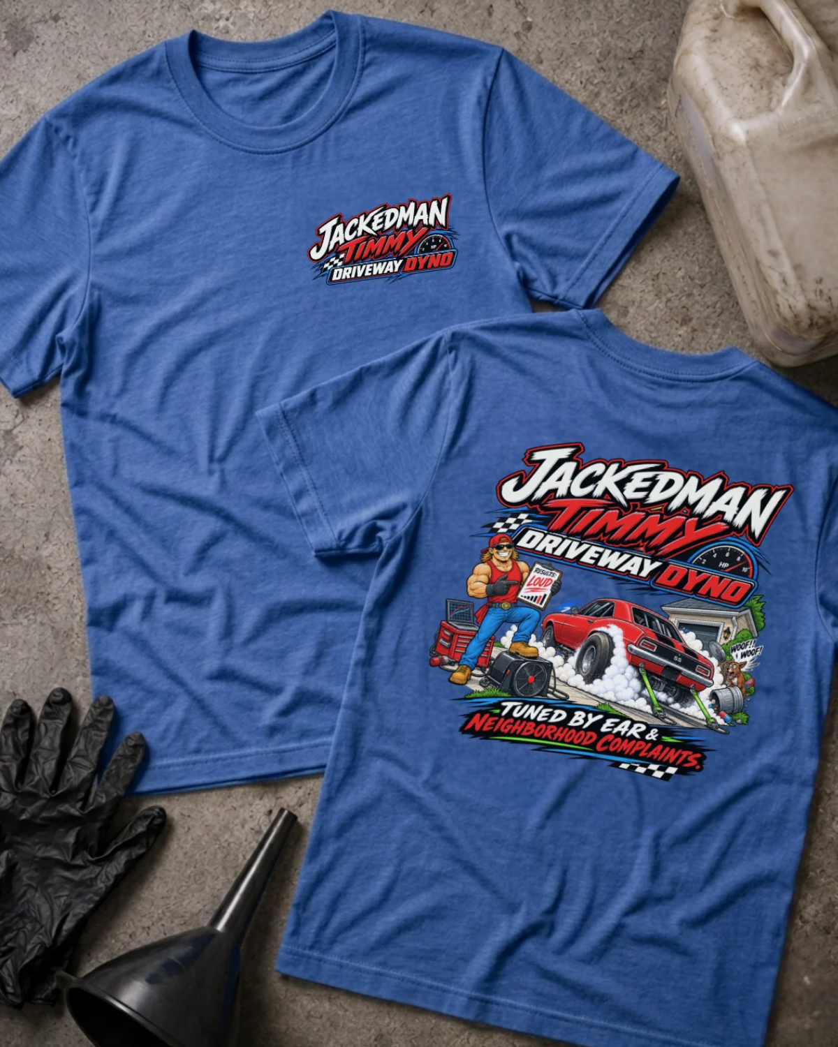 Front and back of Jackedman Timmy Driveway Dyno heather true royal T-shirt with chest logo, muscular man beside a red muscle car amid tire smoke, and “Tuned by ear & neighborhood complaints” slogan.