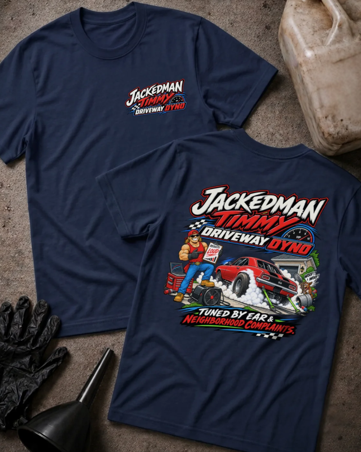 Front and back of Jackedman Timmy Driveway Dyno navy T-shirt with chest logo, muscular man beside a red muscle car amid tire smoke, and “Tuned by ear & neighborhood complaints” slogan.
