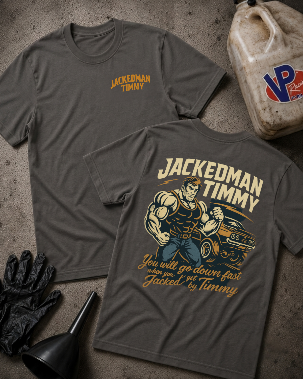 Two dark gray graphic T-shirts laid flat on a textured concrete-like surface, showing both front and back designs. The front has a small yellow 'JACKEDMAN TIMMY' logo on the left chest, and the back features a large illustrated muscular figure beside a car with the text 'JACKEDMAN TIMMY' and 'You will go down fast when you get Jacked by Timmy.