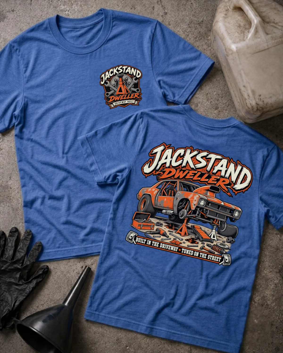 Front and back of heather true royal blue Jackstand Dweller T-shirt with a small chest emblem and orange project car on jack stands back print.