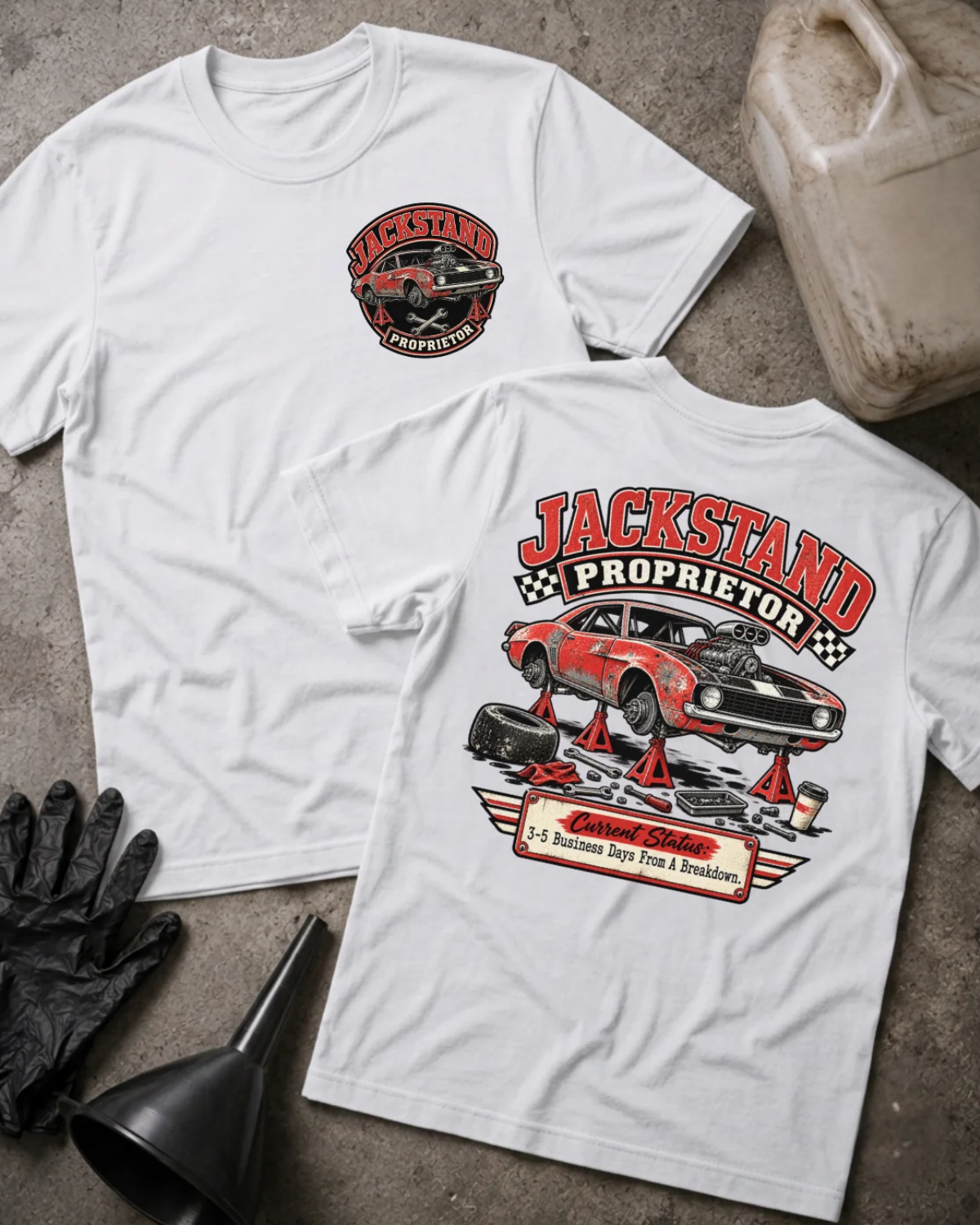 Front and back of Jackstand Proprietor white T-shirt with chest logo, weathered red muscle car on jack stands, and “Current status: 3–5 business days from a breakdown” slogan.