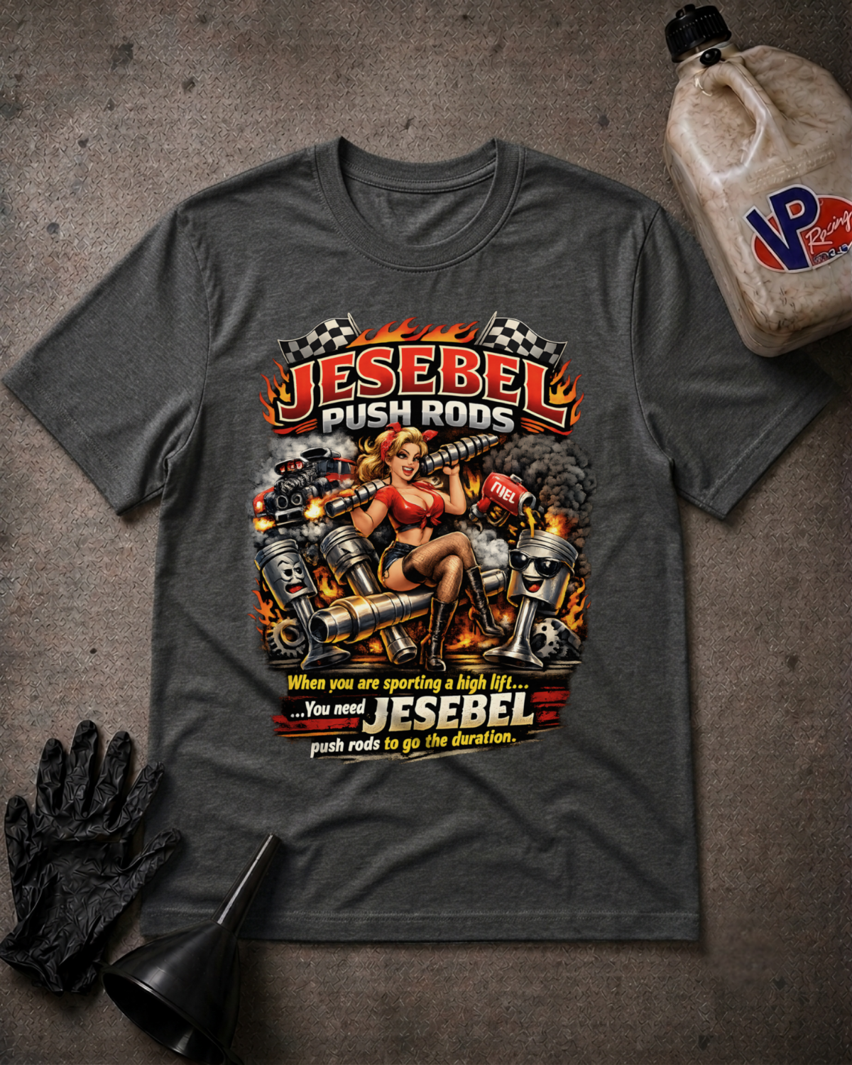 A dark heather gray graphic t-shirt featuring a pin-up style illustration of a woman on a motorcycle with flames and the text 'JESEBEL PUSH RODS' and 'When you are sporting a high lift. You need JESEBEL push rods to go the duration.'