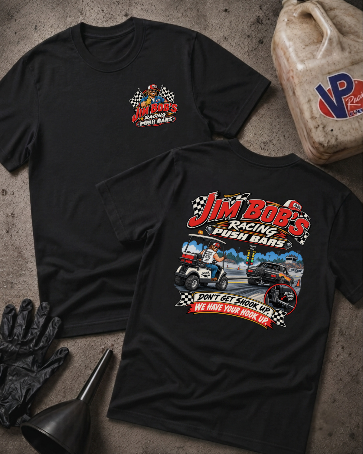 Two black short-sleeve t-shirts with racing graphics for 'Jim Bob's Racing Push Bars' are displayed on a textured gray surface with racing-themed props including a jerrycan, gloves, and a funnel.
