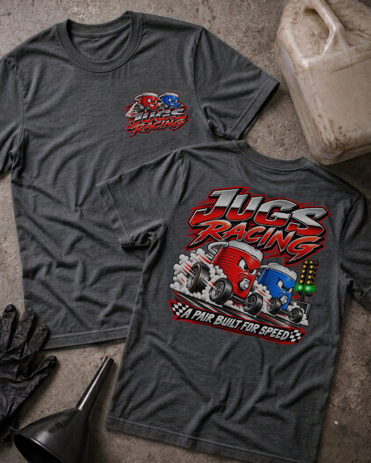 Dark Grey Heather Jugs Racing T-shirt, front and back views featuring red and blue cartoon jugs drag racing beside a starting light, with the slogan “A pair built for speed.”