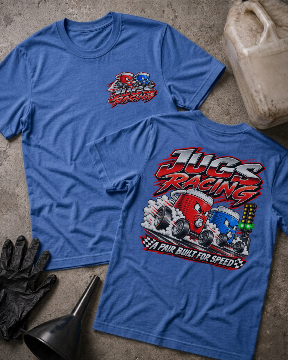 Heather True Royal Jugs Racing T-shirt, front and back views featuring red and blue cartoon jugs drag racing beside a starting light, with the slogan “A pair built for speed.”