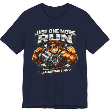 Navy blue t-shirt with a graphic design featuring a muscular character holding a engine and text 'Just One More Run' on a white background.