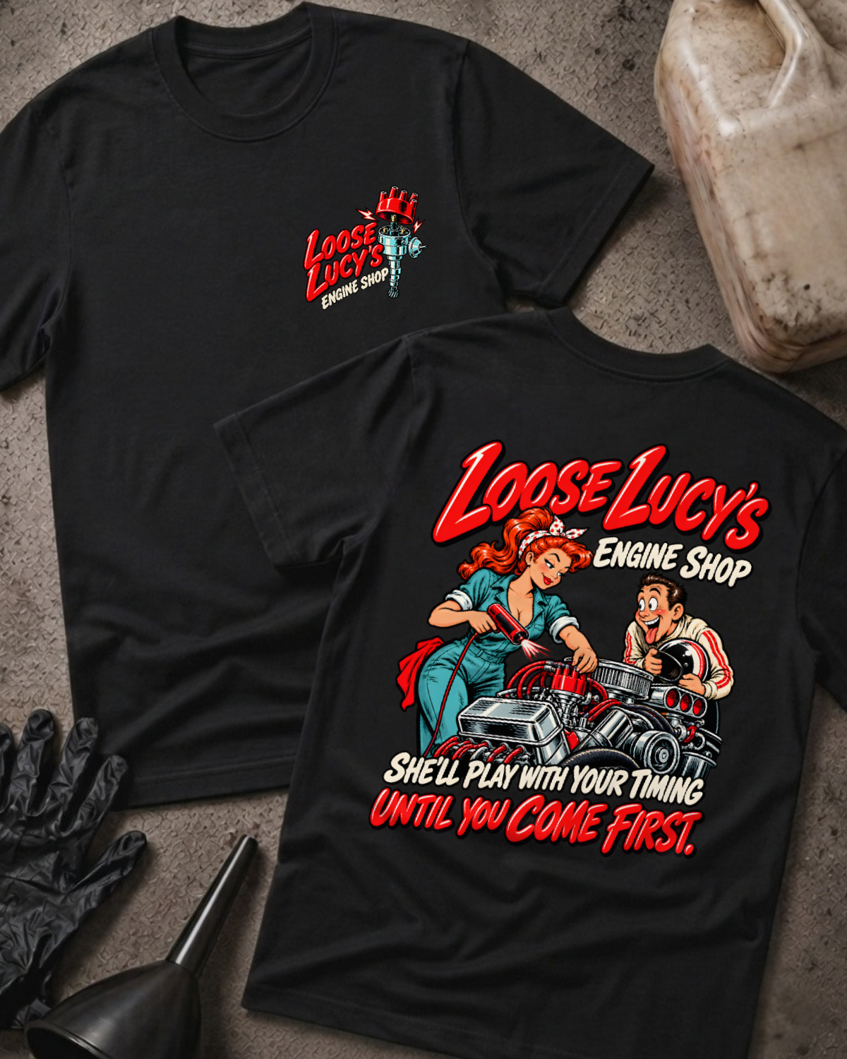 Black Loose Lucy’s Engine Shop T-shirt showing the front chest logo and back cartoon of a woman mechanic timing a hot rod engine with a timing light, “She’ll Play With Your Timing Until You Come First,” with gloves, funnel, and oil jug props.