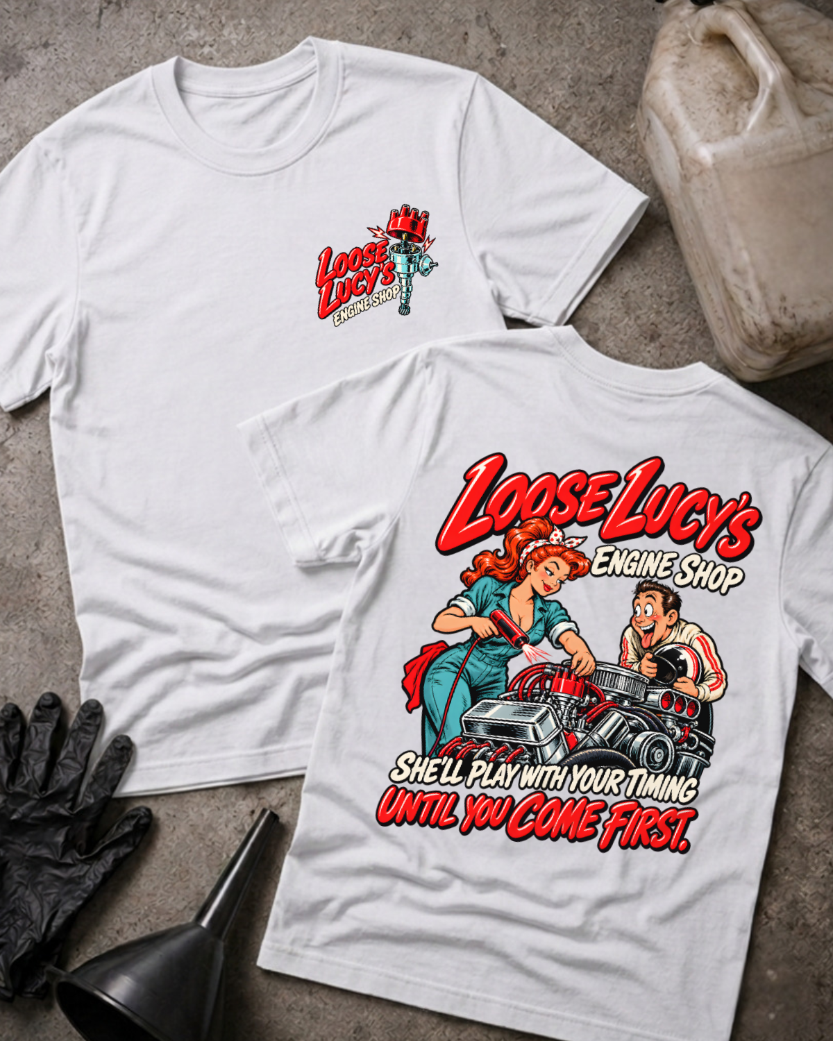 White Loose Lucy’s Engine Shop T-shirt showing the front chest logo and back cartoon of a woman mechanic timing a hot rod engine with a timing light, “She’ll Play With Your Timing Until You Come First,” with gloves, funnel, and oil jug props.