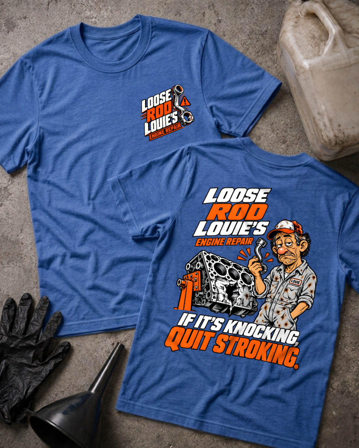 Heather royal blue Loose Rod Louie’s Engine Repair T-shirt, flat lay with the front chest logo and back cartoon mechanic and cracked engine block design reading “If It’s Knocking, Quit Stroking,” styled with gloves, a funnel, and an oil jug.