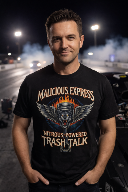 Man wearing a black t-shirt with a graphic design of a wolf and piston with 'Malicious Express Nitrous-Powered Trash Talk' text standing on a drag strip at night