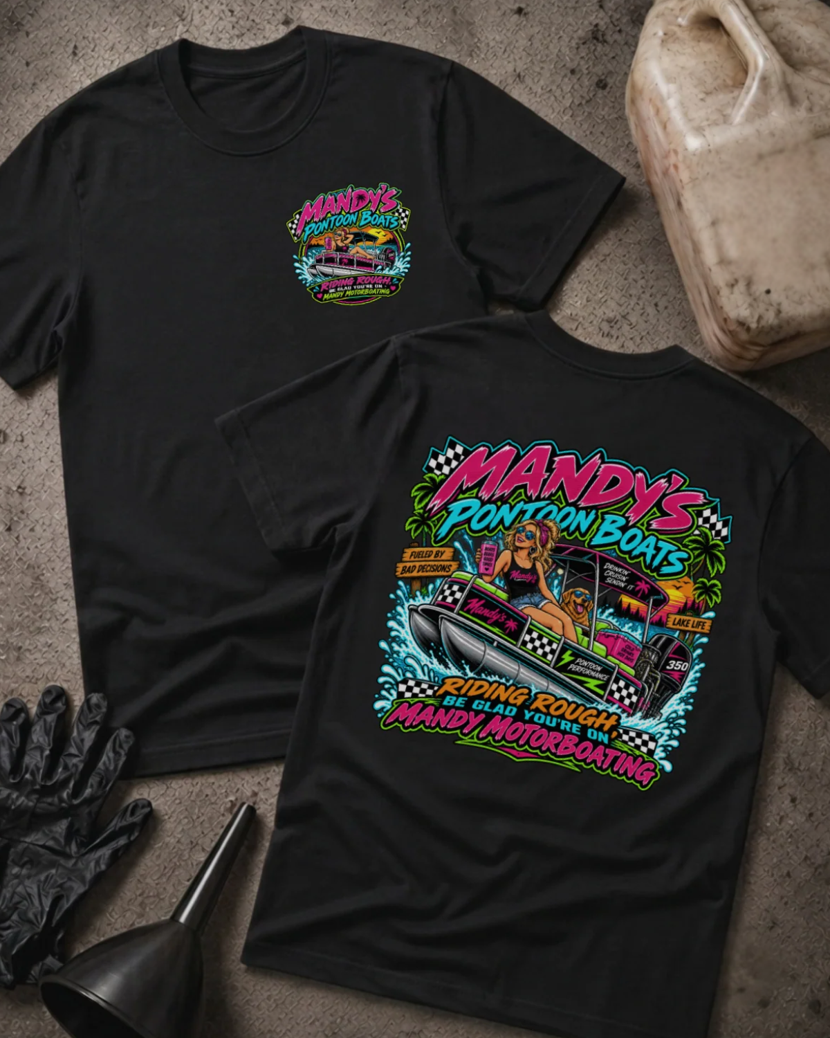 Front and back of Mandy’s Pontoon Boats black T-shirt with chest logo, woman and dog aboard a pontoon boat, and “Riding rough? Be glad you’re on Mandy Motorboating” slogan.
