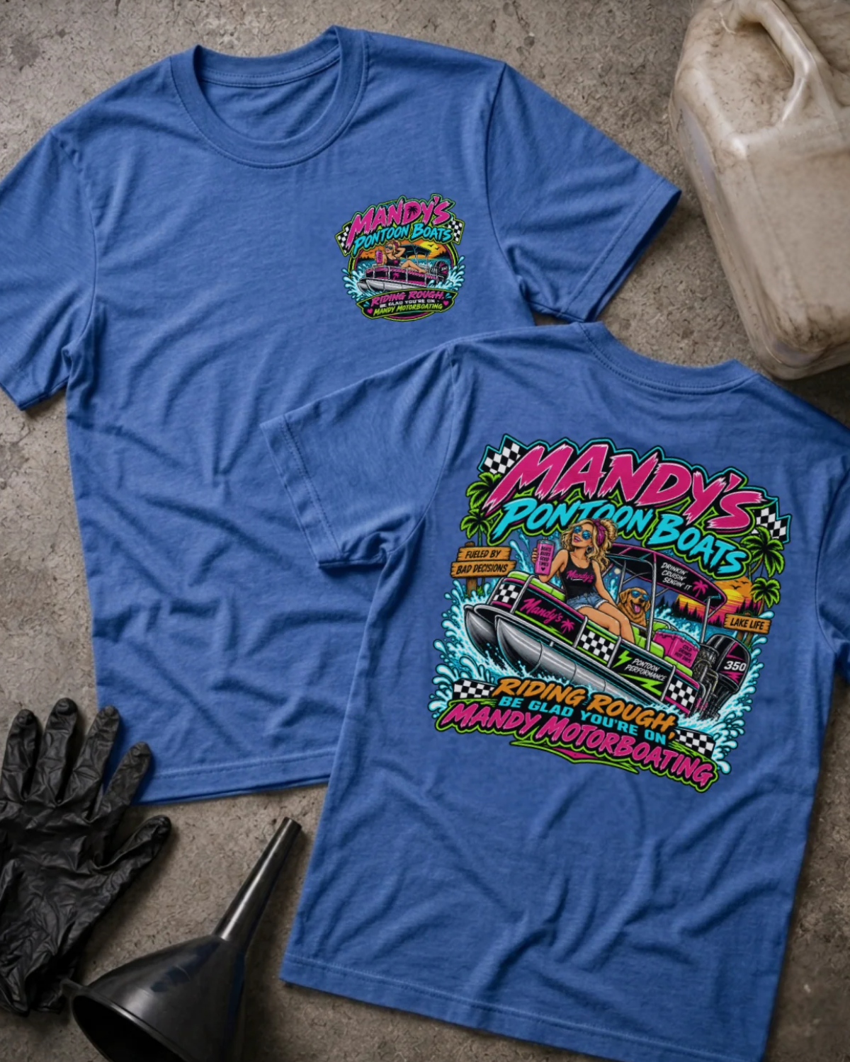 Front and back of Mandy’s Pontoon Boats heather true royal T-shirt with chest logo, woman and dog aboard a pontoon boat, and “Riding rough? Be glad you’re on Mandy Motorboating” slogan.