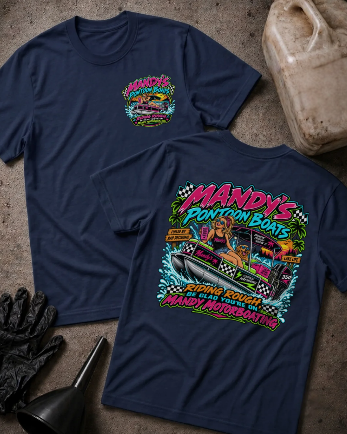Front and back of Mandy’s Pontoon Boats navy T-shirt with chest logo, woman and dog aboard a pontoon boat, and “Riding rough? Be glad you’re on Mandy Motorboating” slogan.