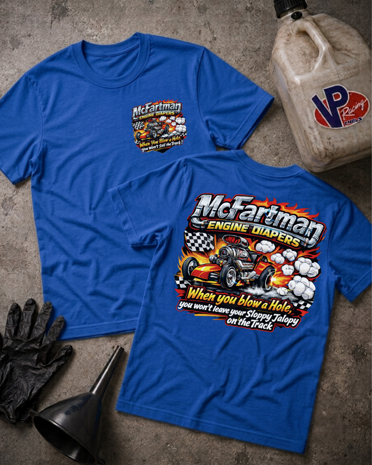 Two blue graphic T-shirts laid flat on a textured gray surface, showing front and back designs for McFariman Engine Radios, with black gloves, a funnel, and a VP Racing jug nearby.