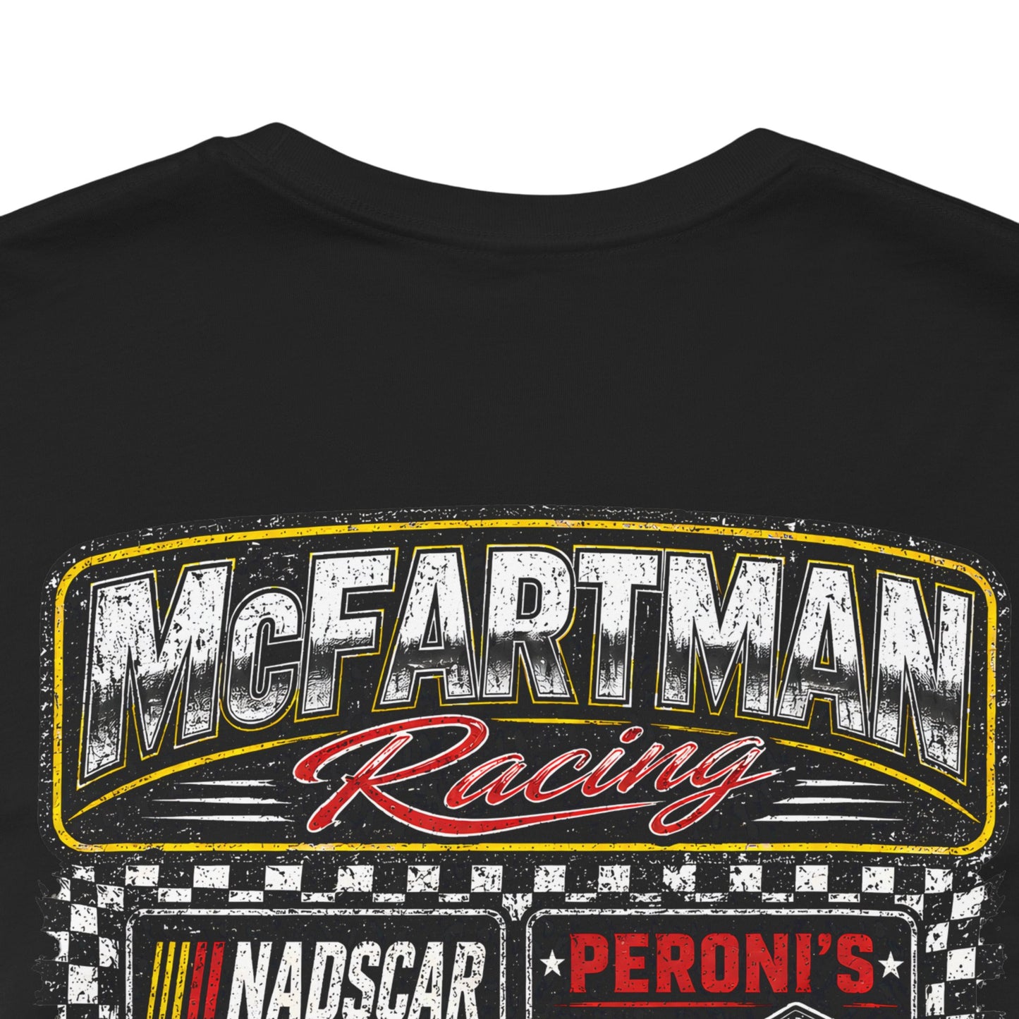 Close-up detail of distressed McFartman Racing “Get Bent!” drag racing shirt graphic showing gritty vintage texture and DTG print detail on black fabric.