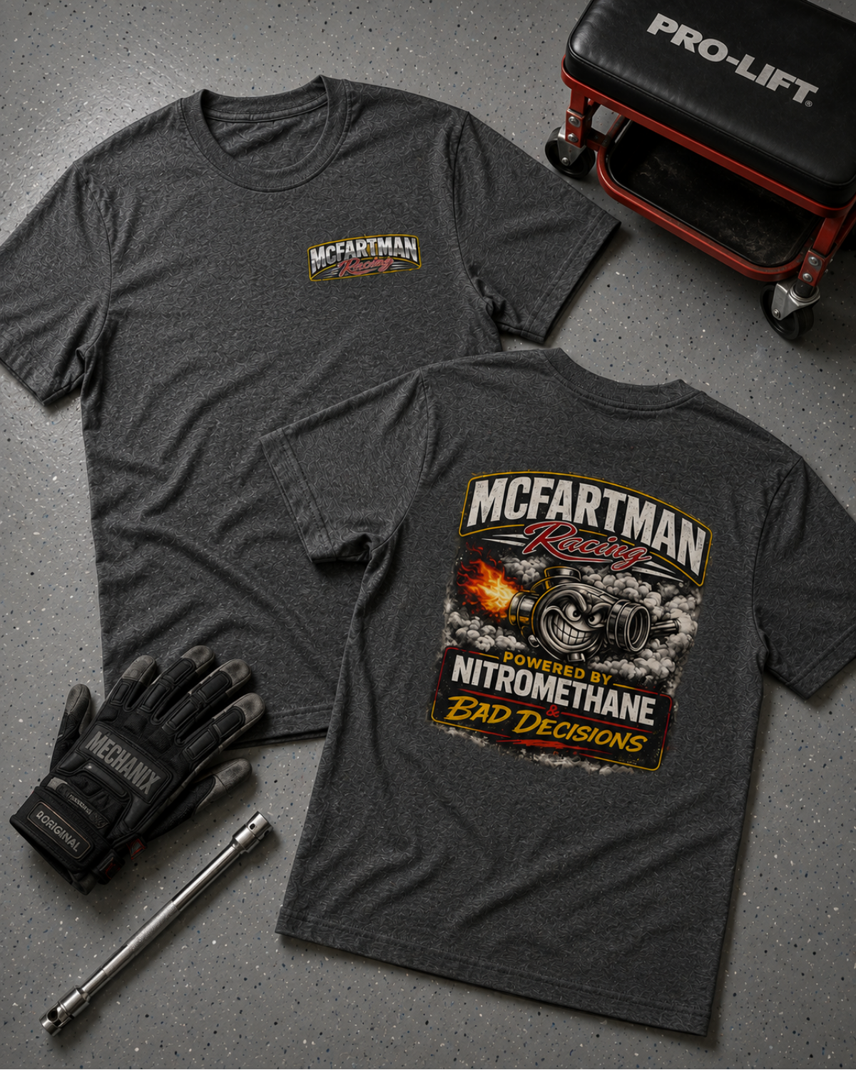 Gray t-shirt with 'McCartman Racing' design, gloves, and tools on a gray surface.