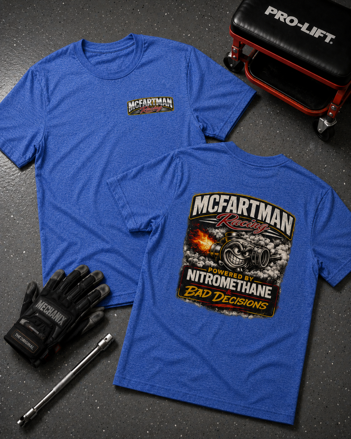 Blue t-shirt with McFartman Racing logo on a dark surface with tools and gloves.