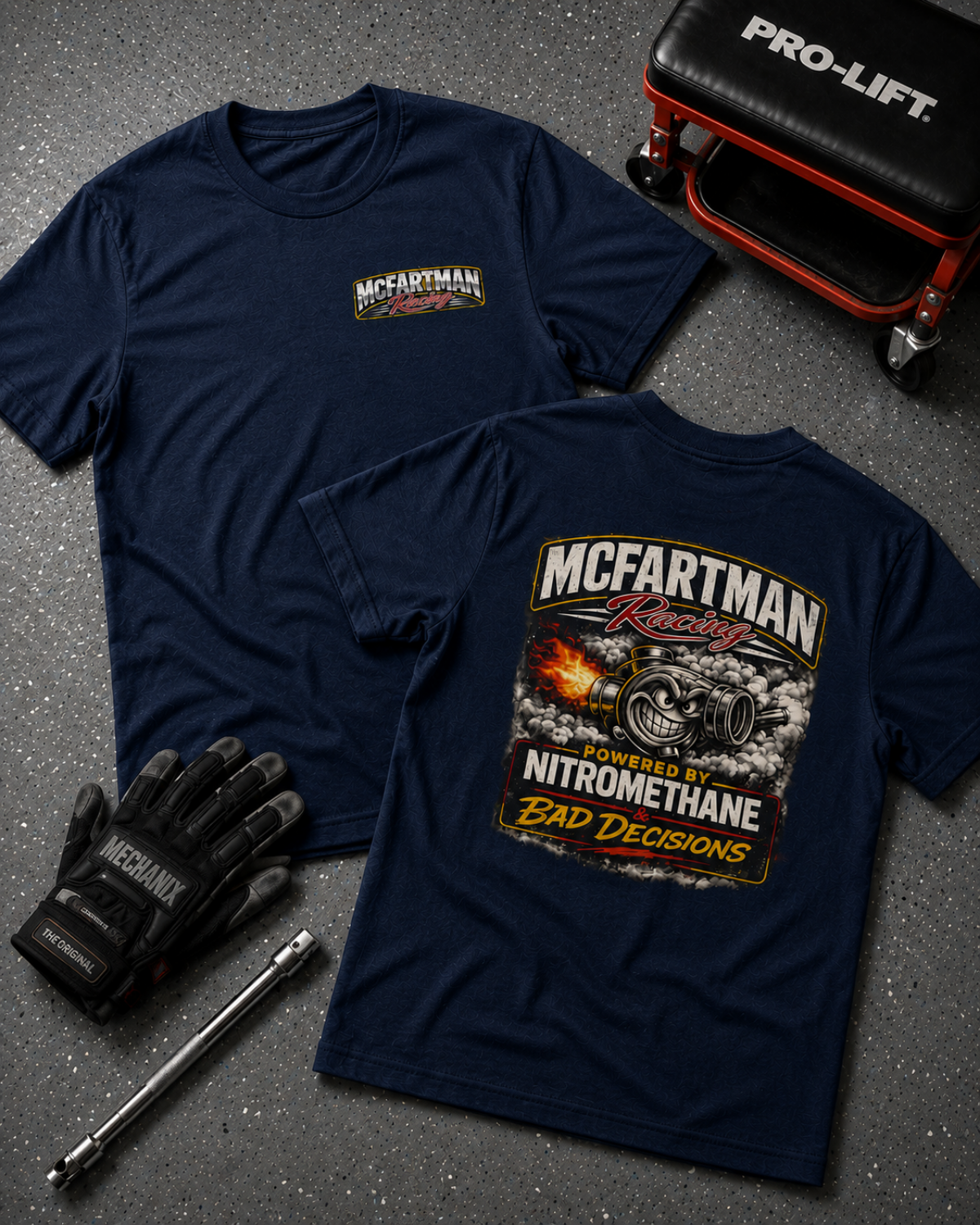 Navy blue t-shirt with McFartman Racing graphic, gloves, and tool on a gray surface.