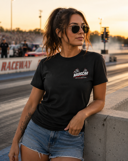 Woman wearing a black t-shirt with a NADSCAR logo at a raceway.