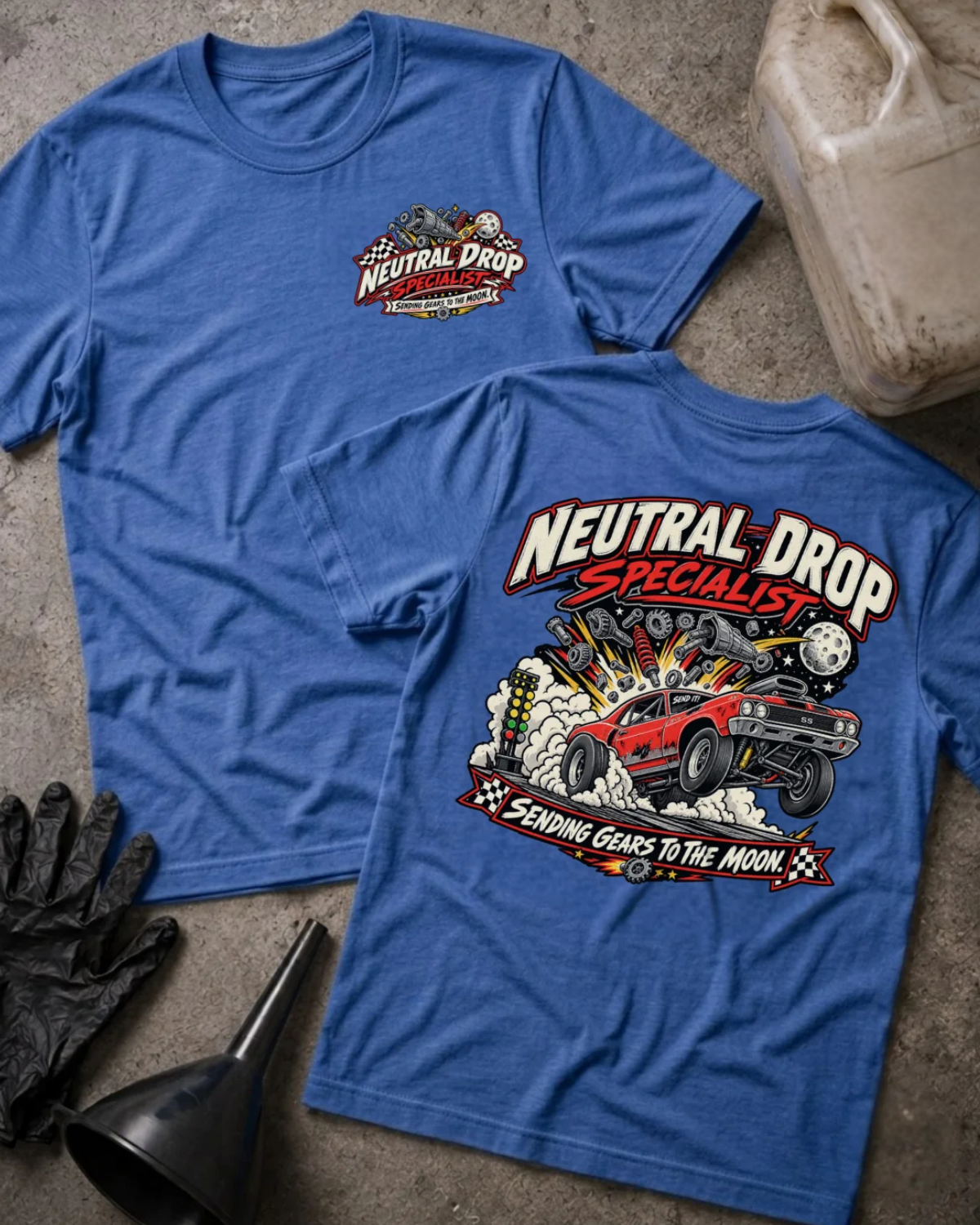Front and back of Neutral Drop Specialist heather true royal T-shirt with chest logo, red muscle car launching amid smoke and flying gears, and “Sending gears to the moon!” slogan.