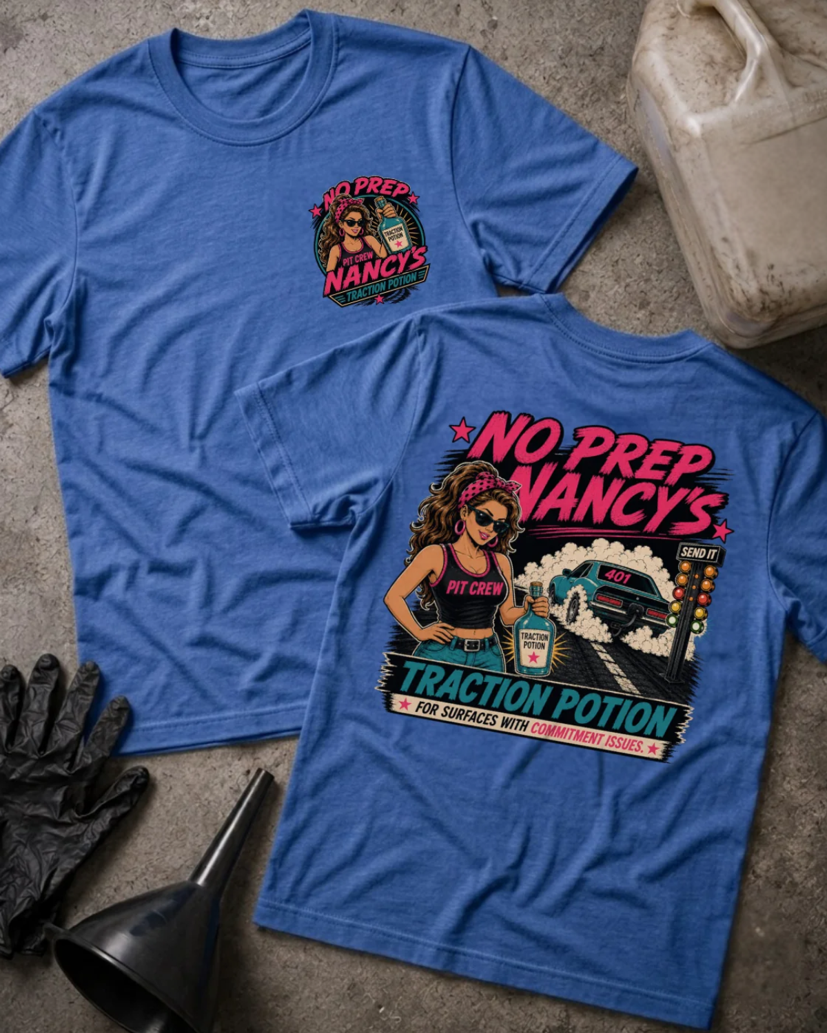 Front and back of No Prep Nancy’s heather true royal T-shirt with chest logo, woman holding traction potion beside a drag car doing a burnout, and “For surfaces with commitment issues” slogan.