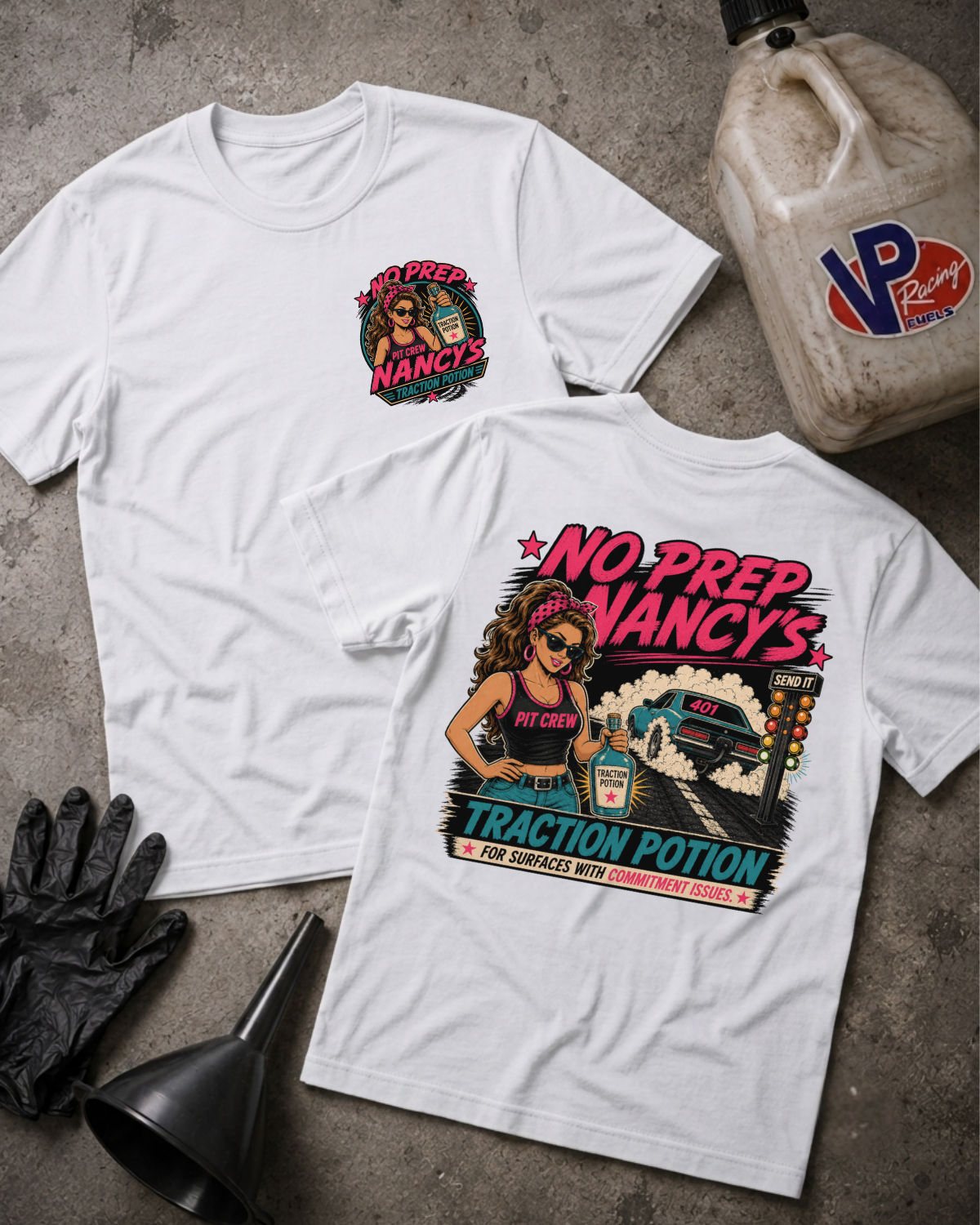 Two white graphic T-shirts laid flat on a concrete surface, showing the front and back designs. The front has a small circular chest graphic, and the back has a large colorful graphic with the text 'NO PREP NANCY'S' and 'TRACTION POTION.