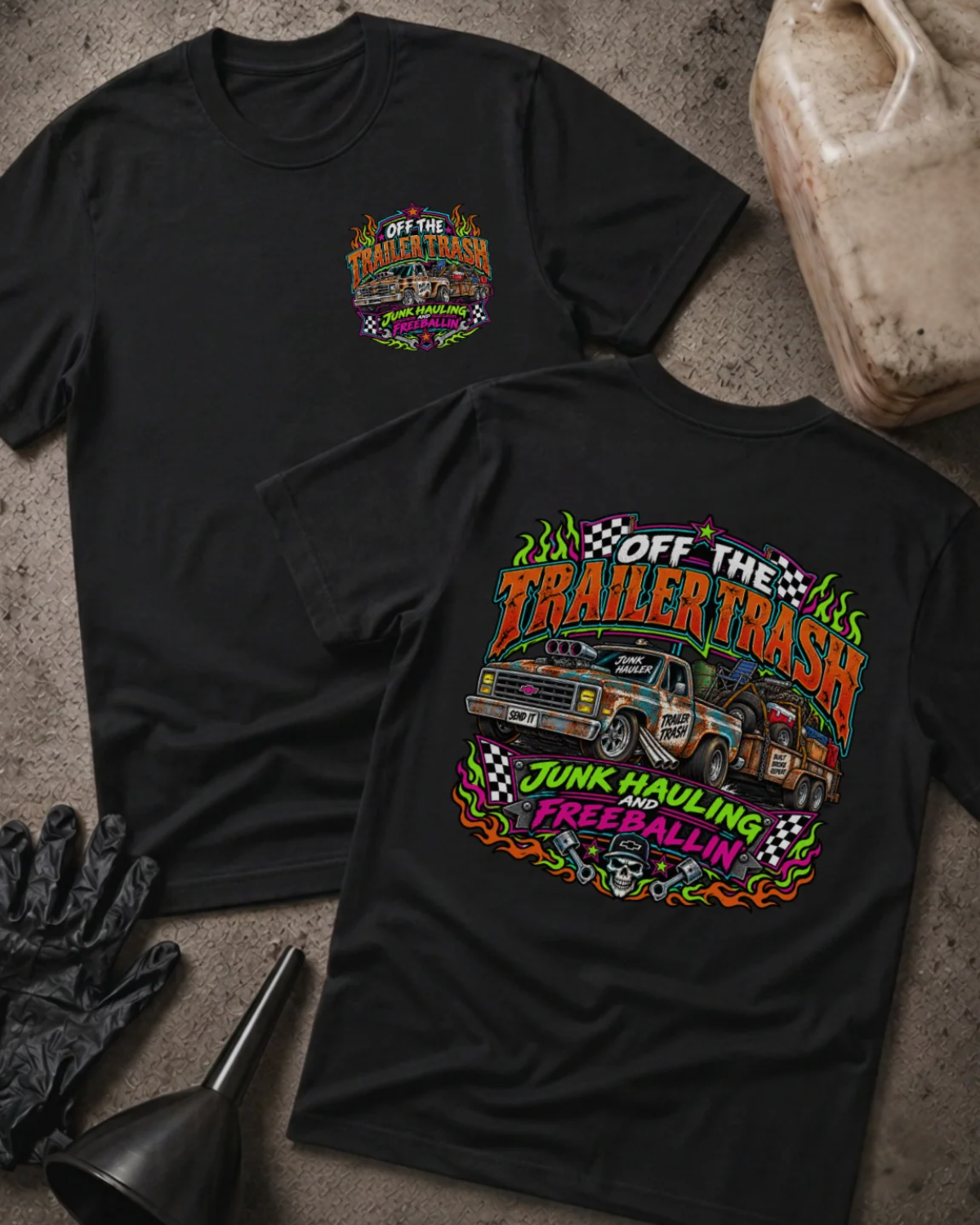 Front and back of Off the Trailer Trash black T-shirt with chest logo, rusty pickup towing a junk-filled trailer, and “Junk hauling and freeballin’” slogan.