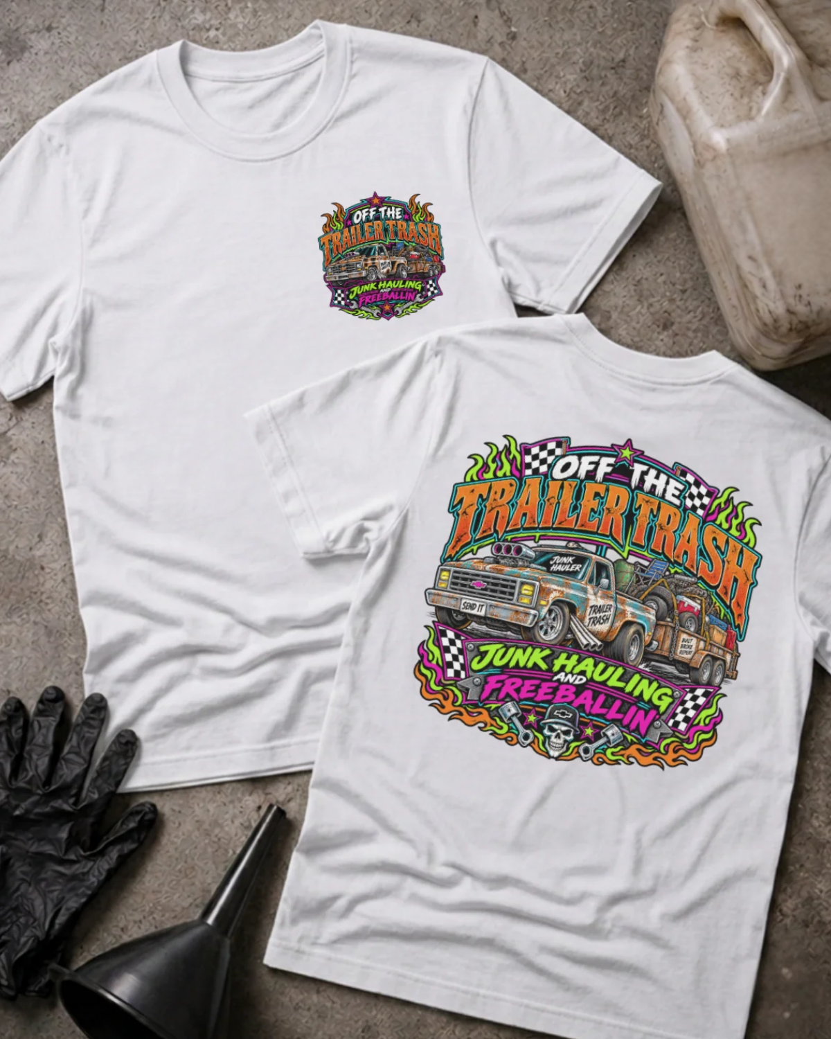  Front and back of Off the Trailer Trash white T-shirt with chest logo, rusty pickup towing a junk-filled trailer, and “Junk hauling and freeballin’” slogan.