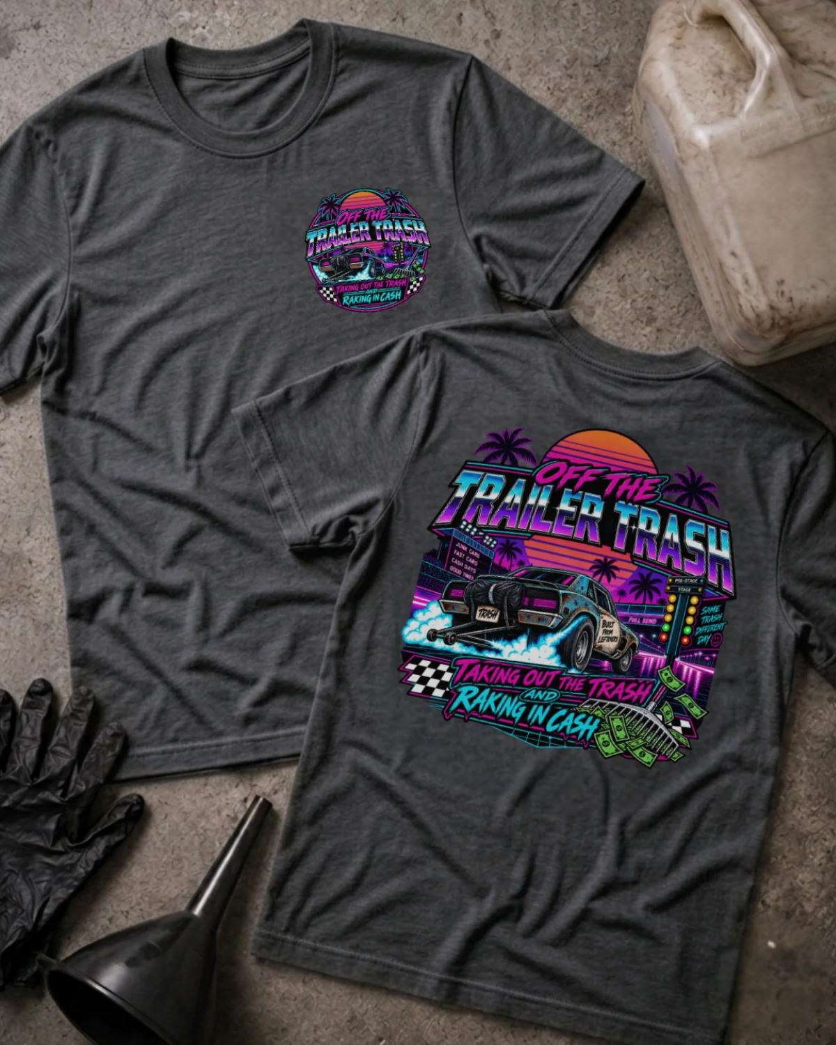 Front and back of Off the Trailer Trash dark grey heather T-shirt with chest logo, drag car beneath a neon sunset and palm trees, and “Taking out the trash and raking in cash” slogan.