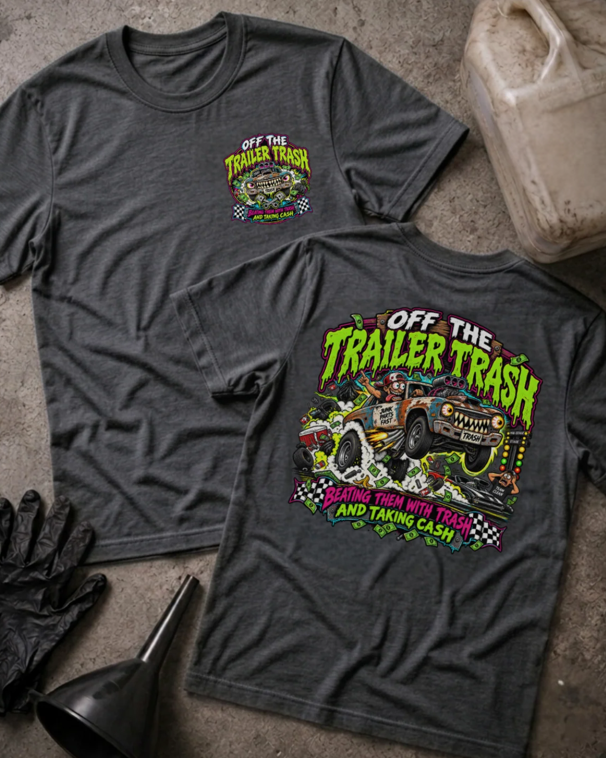 Front and back of Off the Trailer Trash dark grey heather T-shirt with chest logo, rusty drag racing car amid smoke and cash, and “Beating them with trash and taking cash” slogan