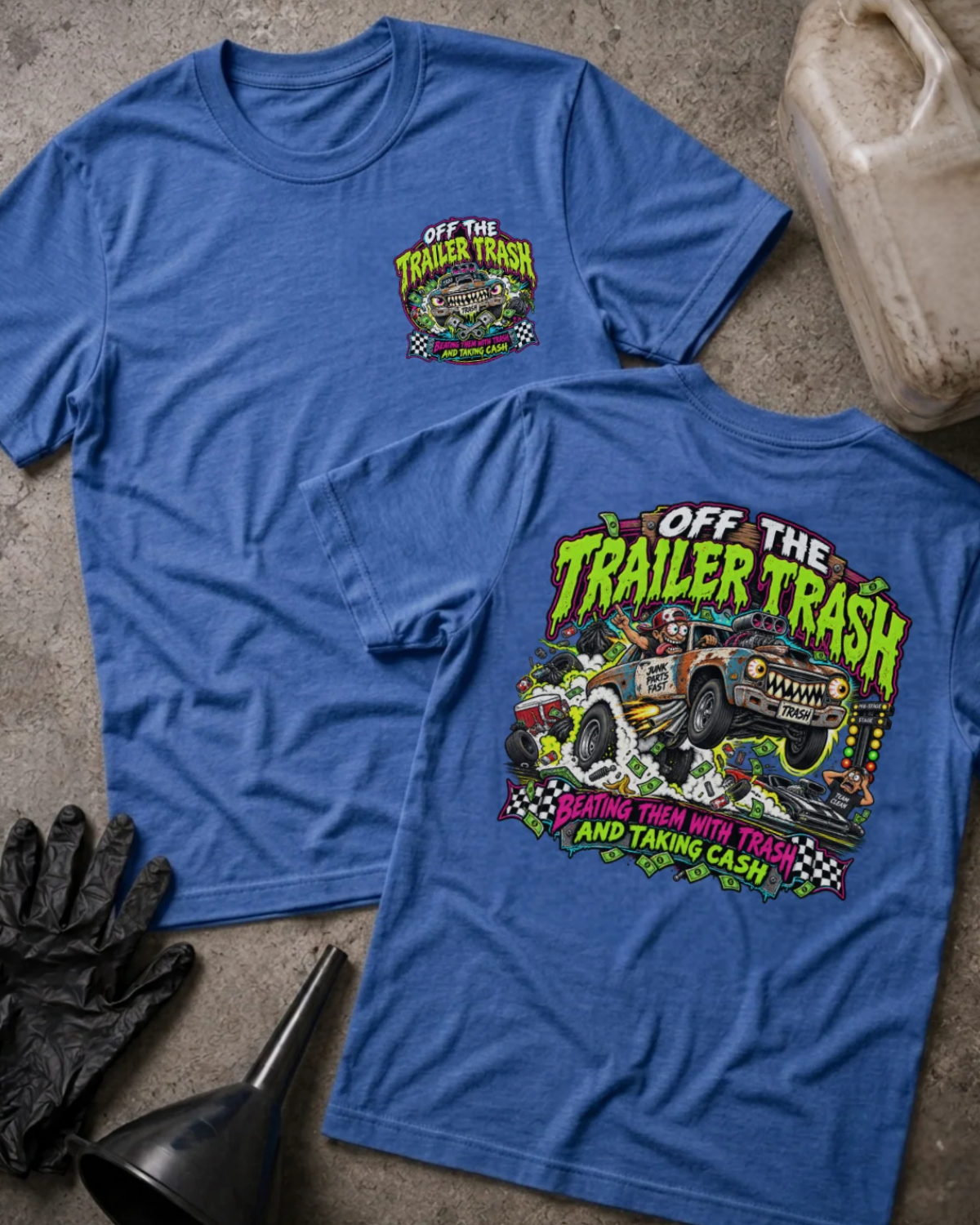 Front and back of Off the Trailer Trash heather true royal T-shirt with chest logo, rusty drag racing car amid smoke and cash, and “Beating them with trash and taking cash” slogan.