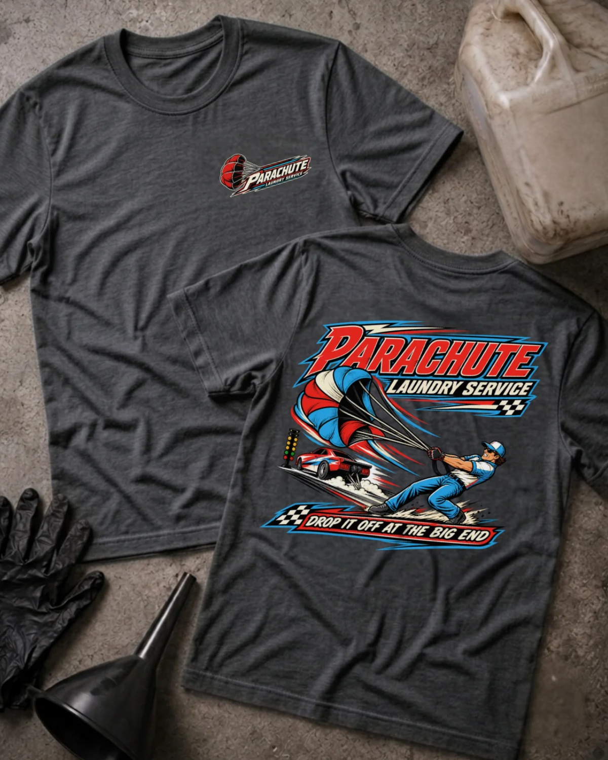 Front and back of Parachute Laundry Service dark grey heather drag racing T-shirt with chest logo, crew member pulling a red, white and blue parachute beside a race car, and “Drop it off at the big end” slogan.