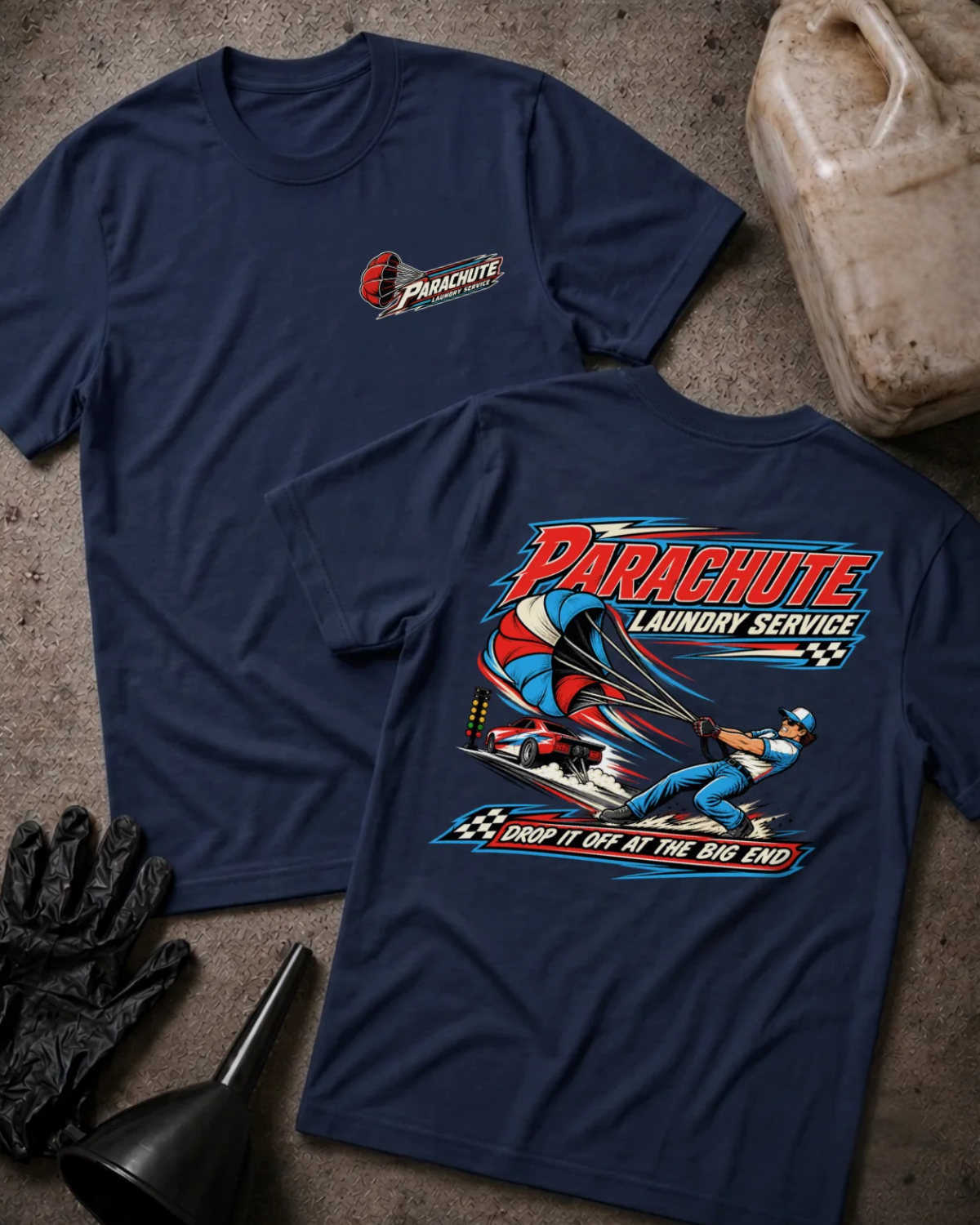 Front and back of Parachute Laundry Service navy drag racing T-shirt with chest logo, crew member pulling a red, white and blue parachute beside a race car, and “Drop it off at the big end” slogan.