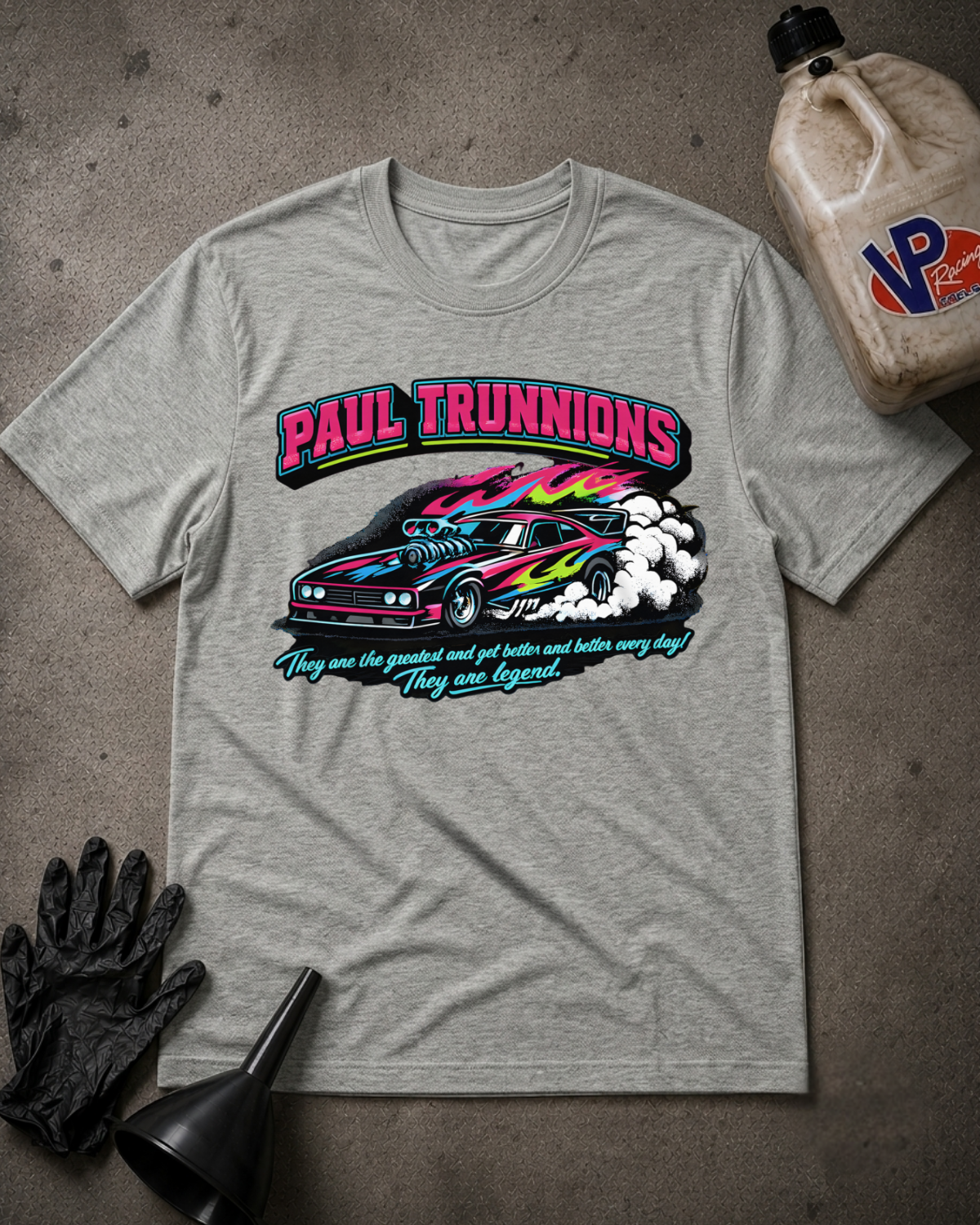 A heather gray graphic t-shirt featuring a colorful print of a race car and the text 'PAUL TRUNNIONS' and 'They are the greatest and get better and better every day They are legend.'