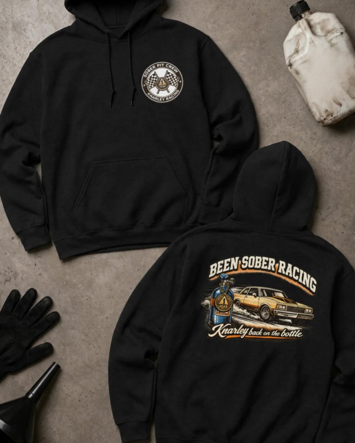 Front and back of black Been Sober Racing hoodie with a Sober Pit Crew chest emblem and gold drag car beside a blue nitrous bottle, reading “Knarley Back on the Bottle.”