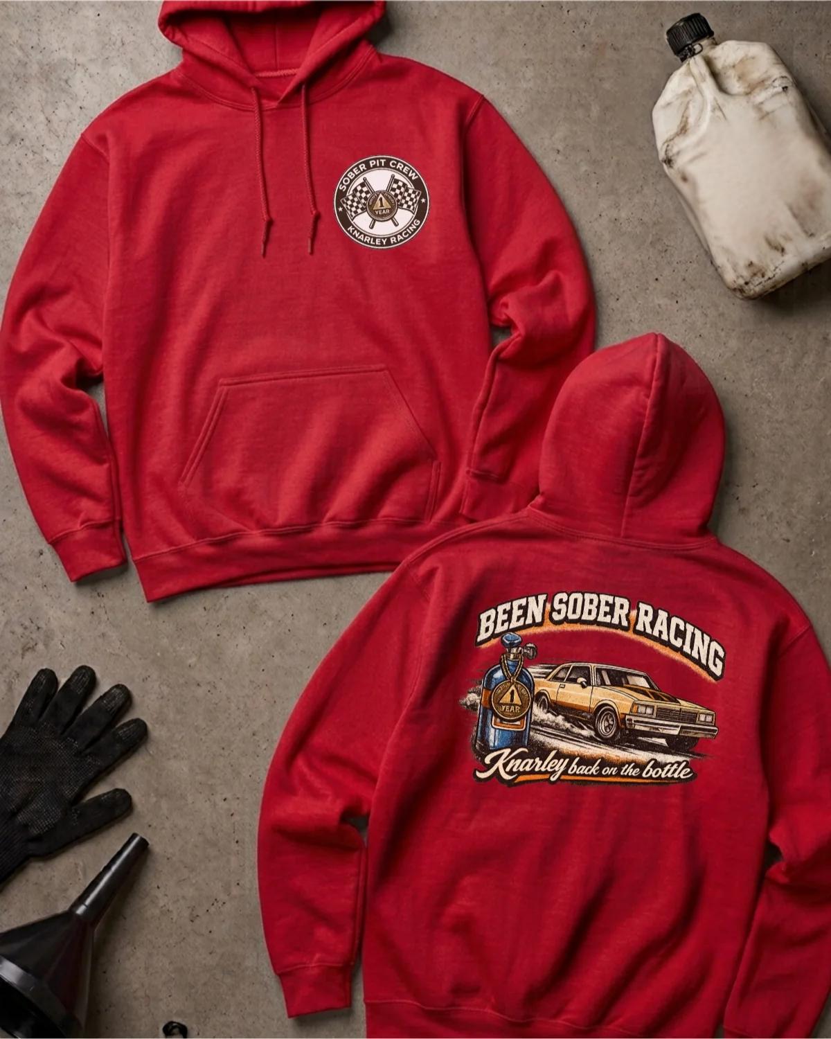 Front and back of red Been Sober Racing hoodie with a Sober Pit Crew chest emblem and gold drag car beside a blue nitrous bottle, reading “Knarley Back on the Bottle.”