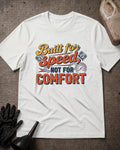 White Built for Speed piston T-shirt featuring yellow, orange, and black “Built for speed, not for comfort” lettering with piston and speedometer graphics.