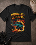 Black Burning Rubber retro car T-shirt featuring a teal supercharged car lifting its front wheels amid orange flames and tire smoke, beneath yellow and orange “Burning Rubber!” lettering.