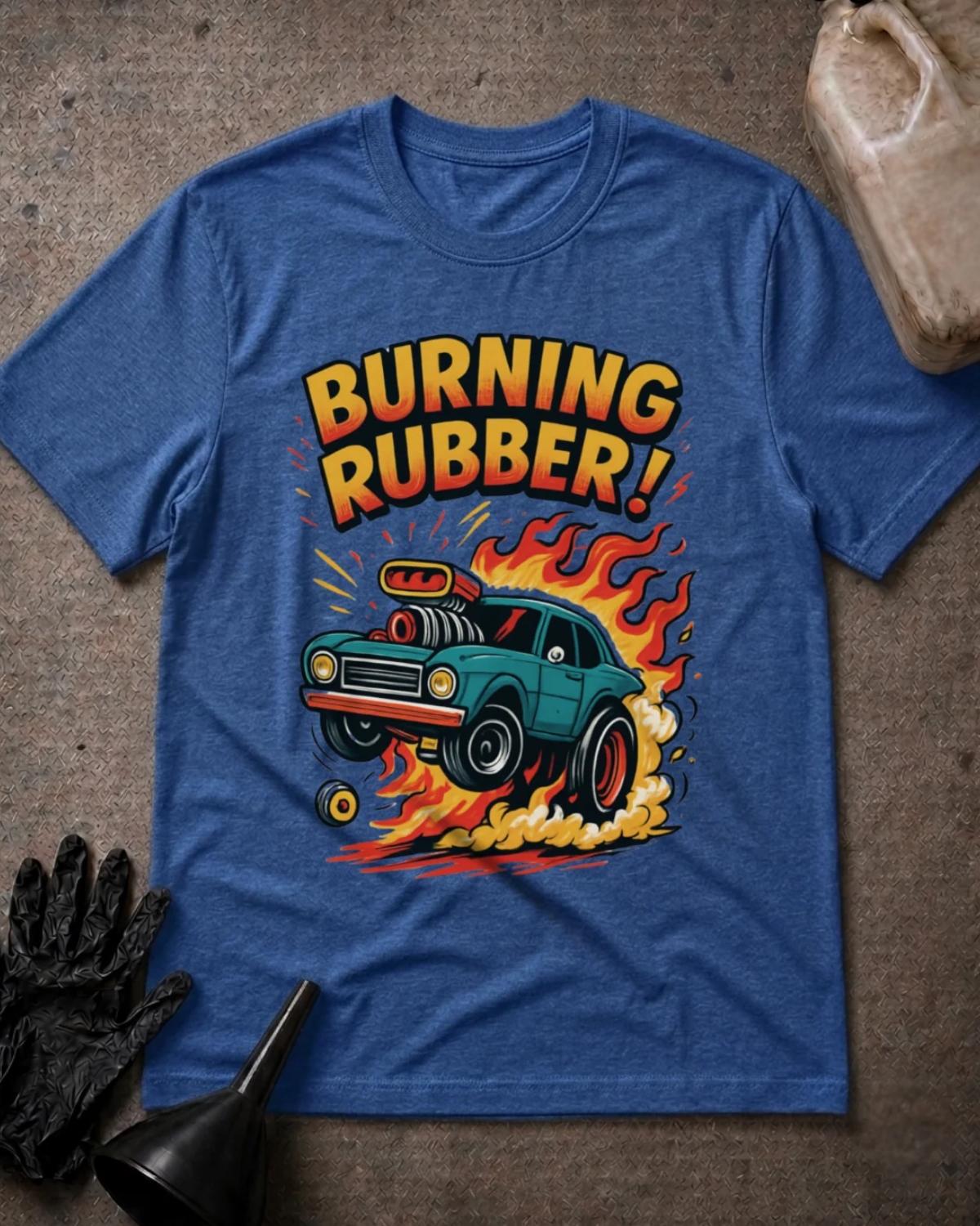 Heather True Royal blue Burning Rubber retro car T-shirt featuring a teal supercharged car lifting its front wheels amid orange flames and tire smoke, beneath yellow and orange “Burning Rubber!” lettering.