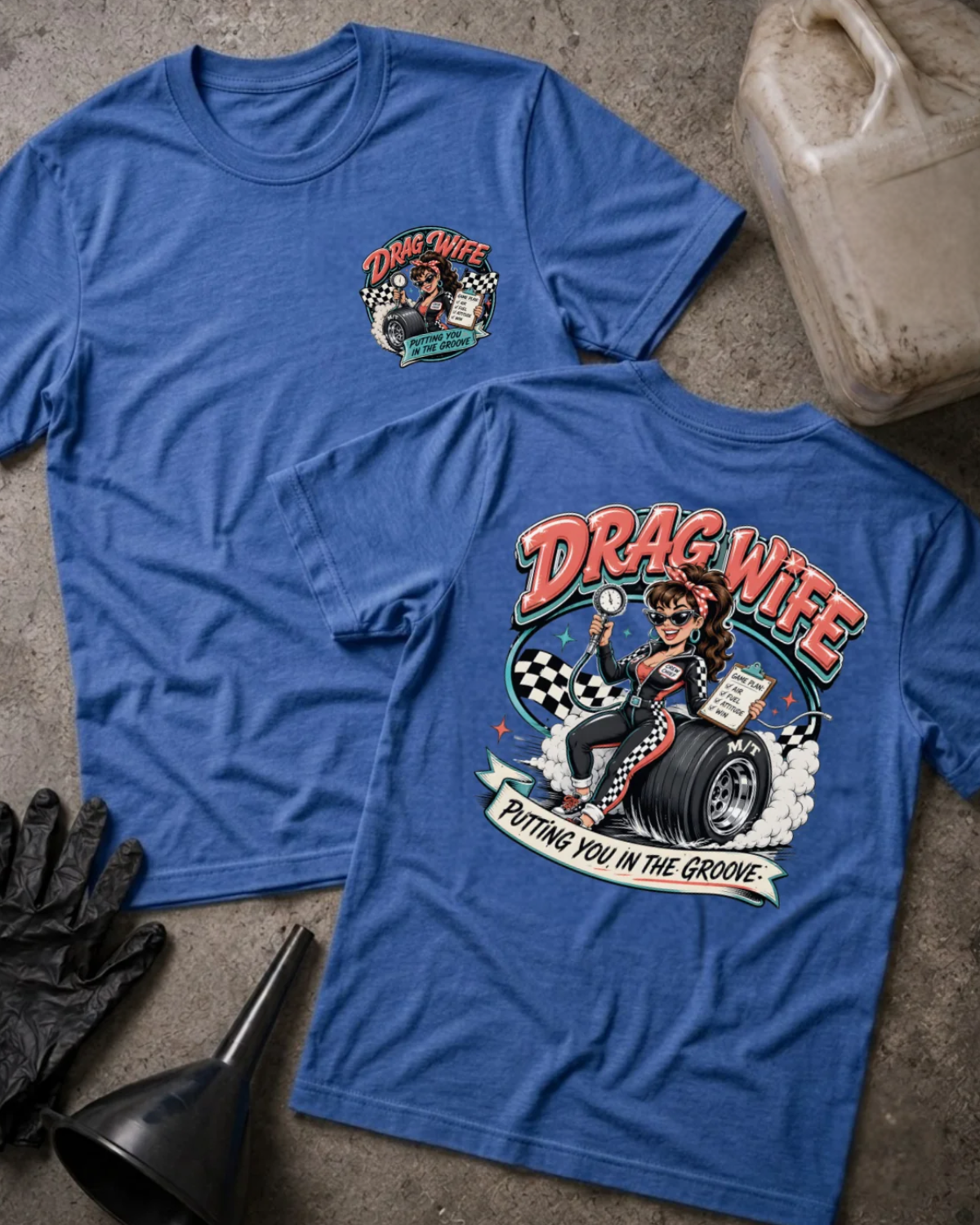 Front and back of heather true royal blue Drag Wife T-shirt with a small chest emblem and woman holding a tire pressure gauge and clipboard on a racing tire back print.