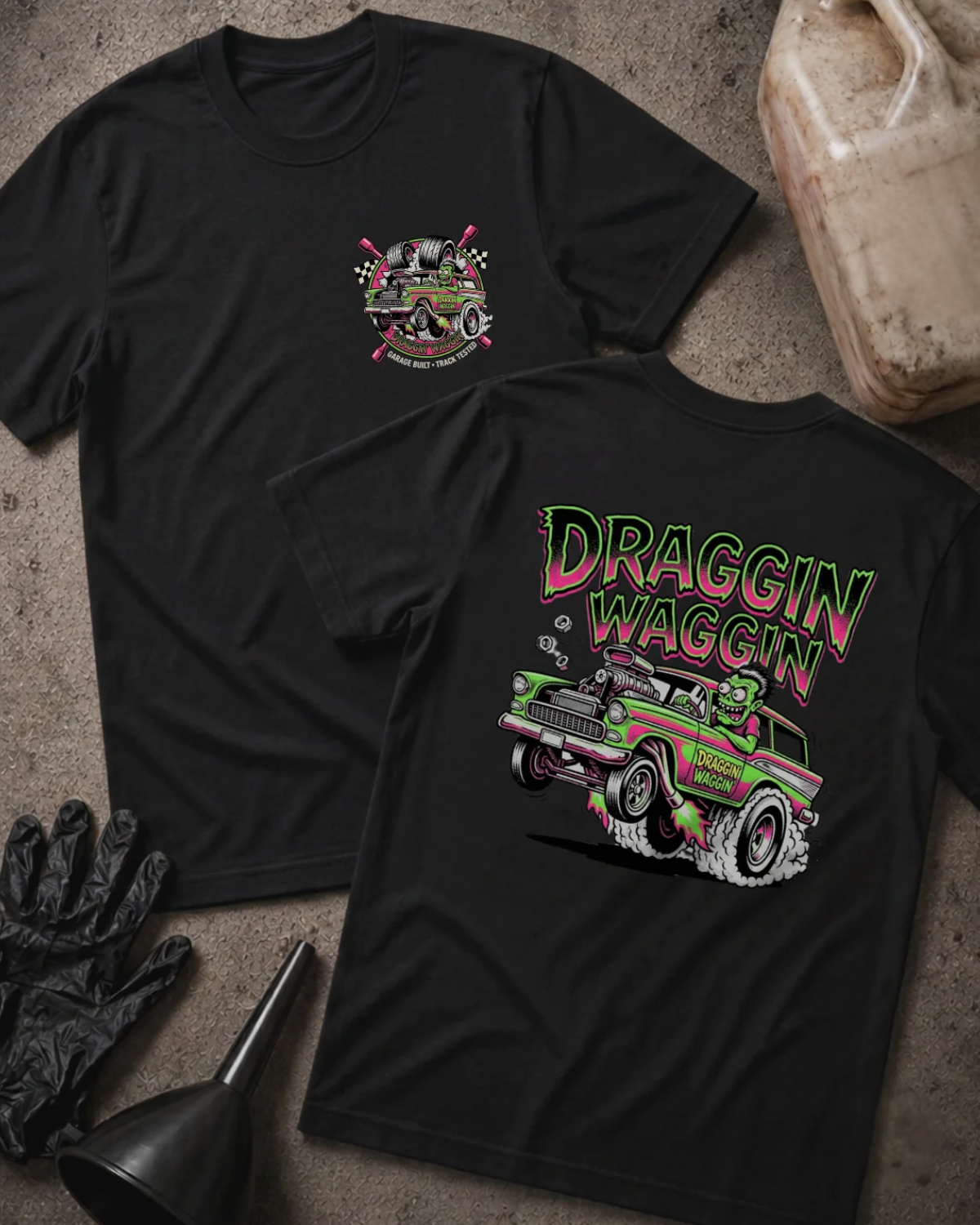 Front and back of black Draggin Waggin T-shirt with a small chest emblem and green and pink hot rod wagon with a cartoon monster driver on the back.