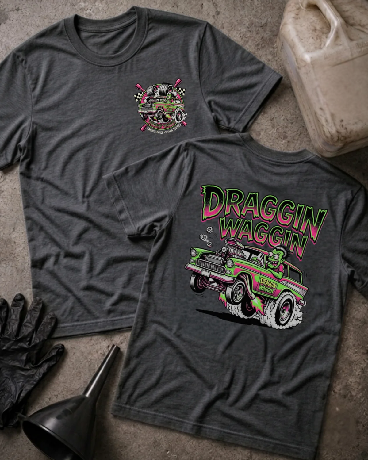 Front and back of dark grey heather Draggin Waggin T-shirt with a small chest emblem and green and pink hot rod wagon with a cartoon monster driver on the back.