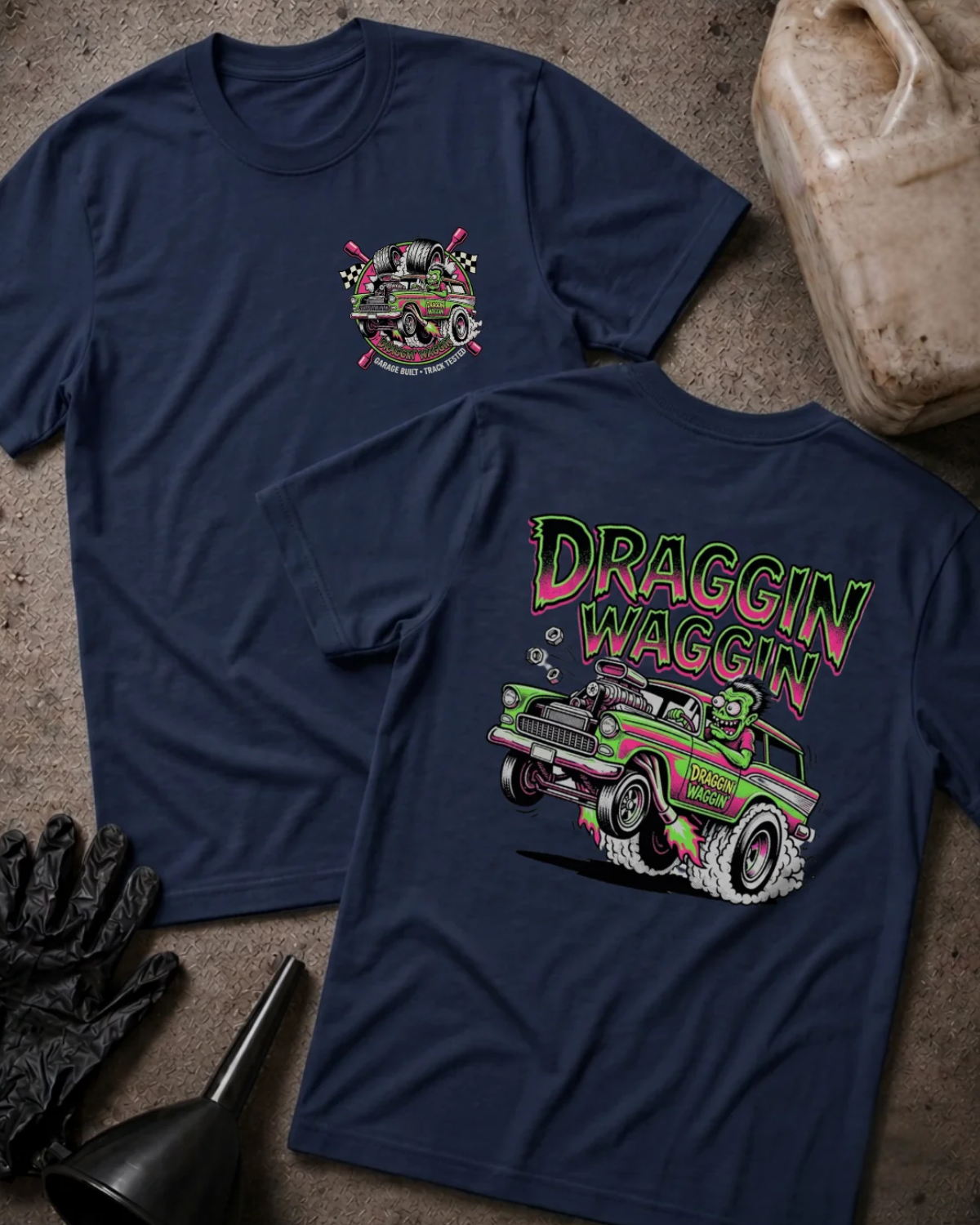 Front and back of navy Draggin Waggin T-shirt with a small chest emblem and green and pink hot rod wagon with a cartoon monster driver on the back.