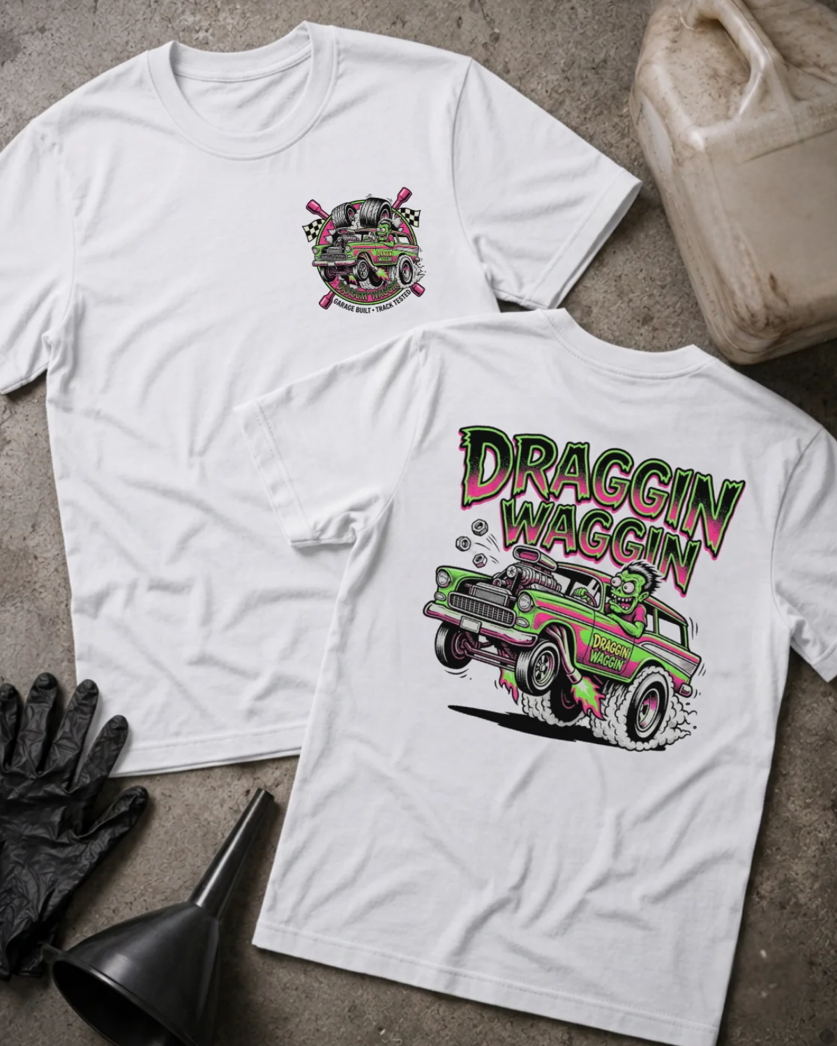 Front and back of white Draggin Waggin T-shirt with a small chest emblem and green and pink hot rod wagon with a cartoon monster driver on the back.